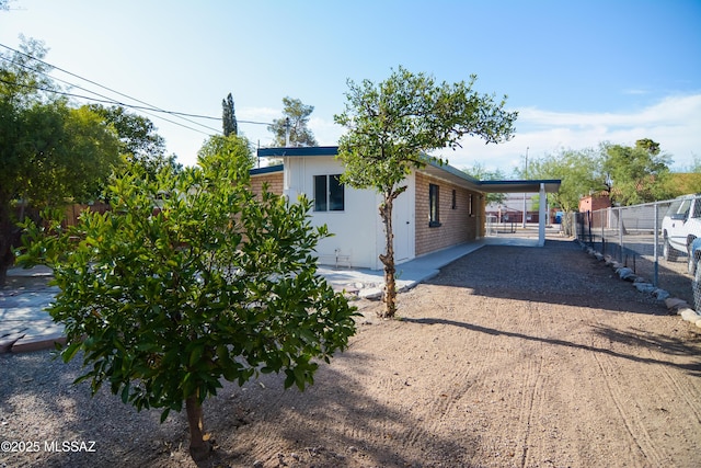 1321 W Saint Clair St, Tucson, AZ 85745 - view of side of property with an attached carport and dirt driveway