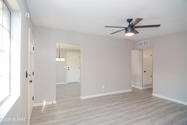 1321 W Saint Clair St, Tucson, AZ 85745 - empty room featuring light wood-type flooring, ceiling fan, and baseboards