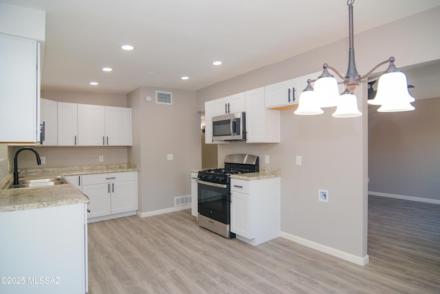 1321 W Saint Clair St, Tucson, AZ 85745 - kitchen featuring stainless steel appliances, a sink, light wood finished floors, baseboards, and recessed lighting