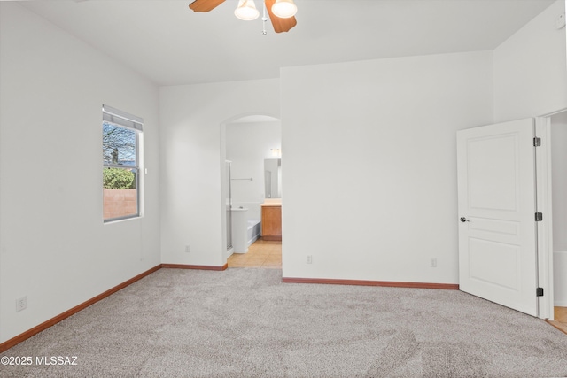 215 E Placita Lago Del Mago, Sahuarita, AZ 85629 - spare room featuring ceiling fan, arched walkways, light colored carpet, and baseboards