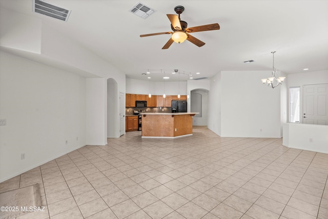 215 E Placita Lago Del Mago, Sahuarita, AZ 85629 - unfurnished living room with arched walkways, ceiling fan, a chandelier, and light tile patterned floors