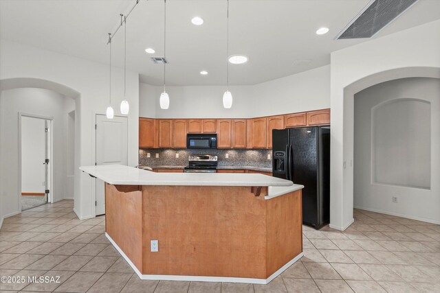 215 E Placita Lago Del Mago, Sahuarita, AZ 85629 - kitchen featuring black appliances, arched walkways, light tile patterned floors, backsplash, and recessed lighting