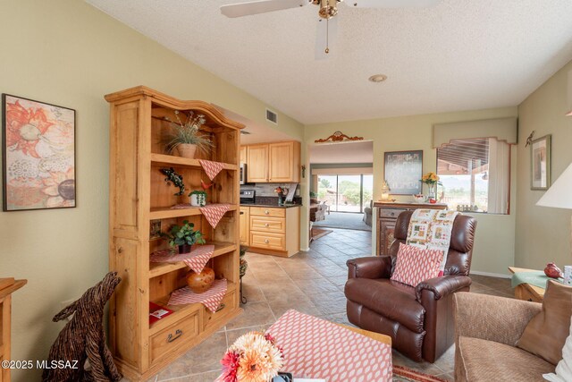 781 W Desert Ridge Dr, Green Valley, AZ 85622 - living room featuring ceiling fan, a textured ceiling, and light tile patterned flooring