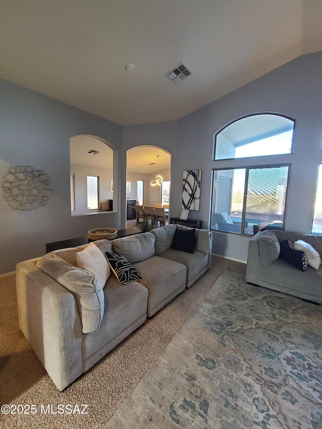 17144 S Scarlet Cliff Pl, Vail, AZ 85641 - carpeted living room with arched walkways, plenty of natural light, and baseboards