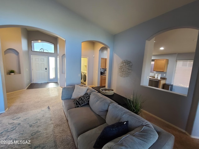 17144 S Scarlet Cliff Pl, Vail, AZ 85641 - living area with separate washer and dryer, carpet flooring, baseboards, arched walkways, and vaulted ceiling