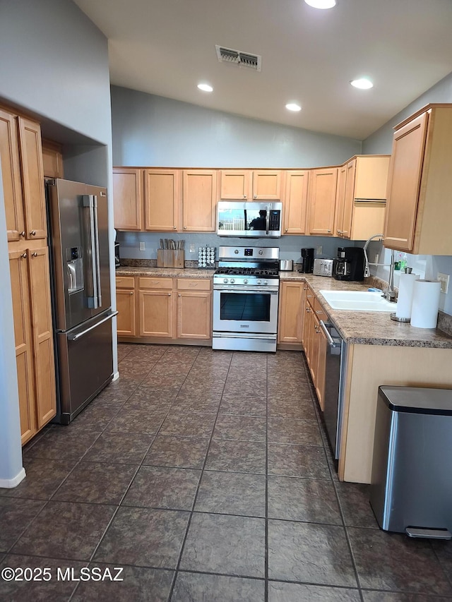 17144 S Scarlet Cliff Pl, Vail, AZ 85641 - kitchen with stainless steel appliances, vaulted ceiling, light brown cabinets, a sink, and recessed lighting