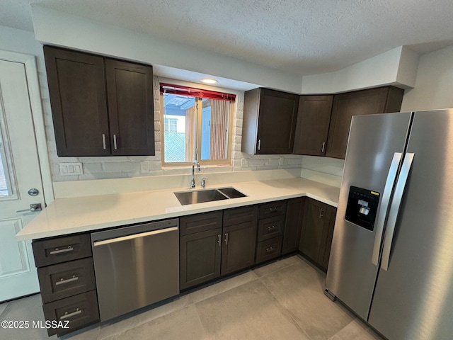 516 E Linden St, Tucson, AZ 85705 - kitchen featuring stainless steel appliances, a sink, dark brown cabinets, light countertops, and a textured ceiling