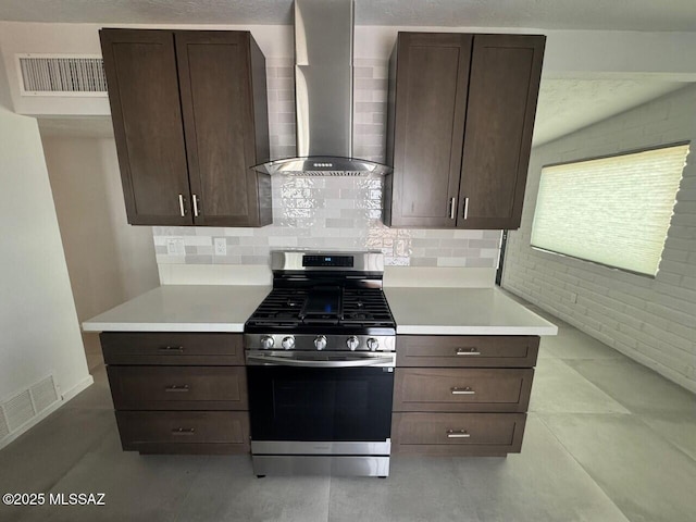 516 E Linden St, Tucson, AZ 85705 - kitchen featuring stainless steel range with gas stovetop, wall chimney exhaust hood, light countertops, and dark brown cabinetry