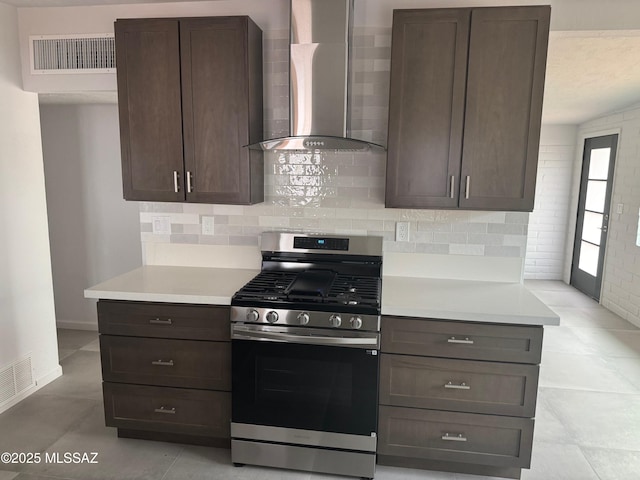 516 E Linden St, Tucson, AZ 85705 - kitchen with wall chimney range hood, stainless steel range with gas cooktop, light countertops, and tasteful backsplash