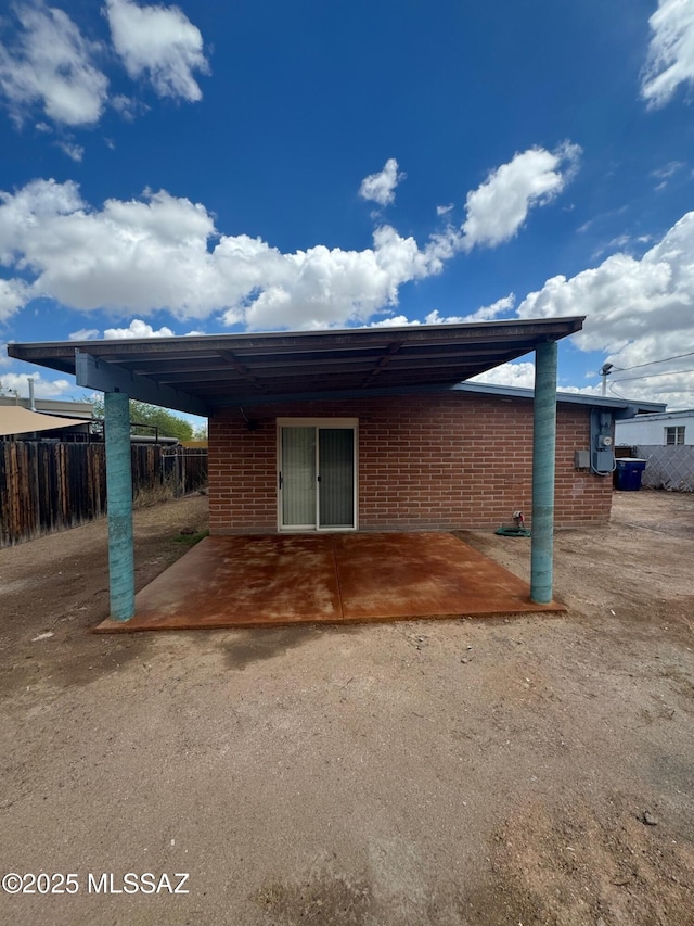 516 E Linden St, Tucson, AZ 85705 - rear view of property with a patio area and brick siding