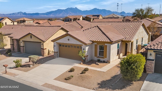 329 W Vuelta Friso, Sahuarita, AZ 85629 - view of front of house with stucco siding, a tiled roof, an attached garage, a mountain view, and driveway