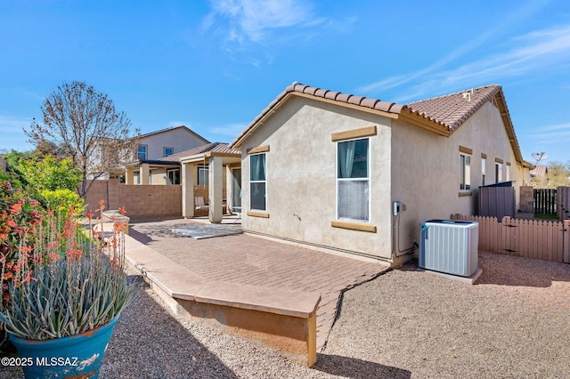 329 W Vuelta Friso, Sahuarita, AZ 85629 - back of property with central air condition unit, a patio, a fenced backyard, stucco siding, and a tiled roof