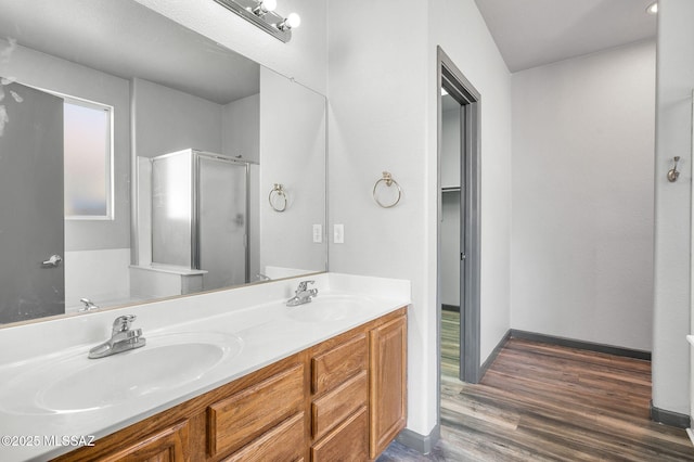 329 W Vuelta Friso, Sahuarita, AZ 85629 - bathroom with a shower stall, wood finished floors, double vanity, and baseboards