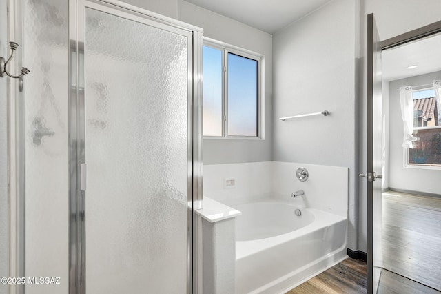 329 W Vuelta Friso, Sahuarita, AZ 85629 - bathroom with a bath, a shower stall, wood finished floors, and baseboards