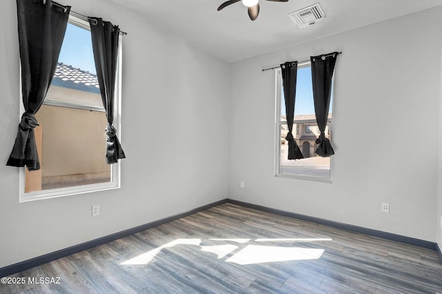 329 W Vuelta Friso, Sahuarita, AZ 85629 - unfurnished room featuring healthy amount of natural light, wood finished floors, a ceiling fan, and baseboards