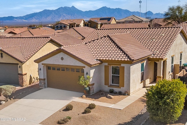 329 W Vuelta Friso, Sahuarita, AZ 85629 - view of front of home featuring a mountain view, stucco siding, an attached garage, and driveway
