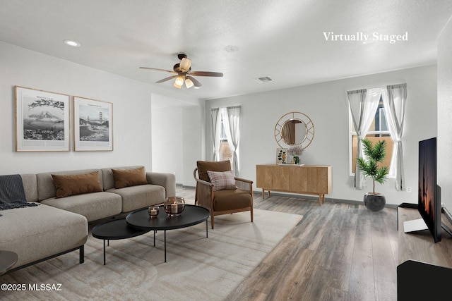 329 W Vuelta Friso, Sahuarita, AZ 85629 - living area featuring healthy amount of natural light, a ceiling fan, wood finished floors, and baseboards