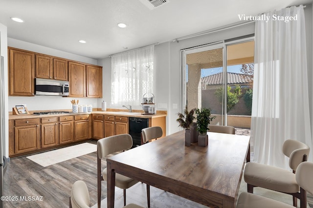 329 W Vuelta Friso, Sahuarita, AZ 85629 - kitchen with stainless steel appliances, wood finished floors, brown cabinets, light countertops, and recessed lighting