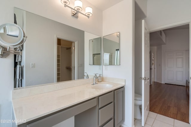6061 N Tocito Pl, Tucson, AZ 85718 - bathroom featuring tile patterned flooring, vanity, toilet, and a spacious closet