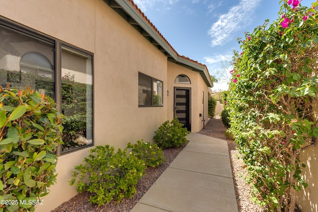 6061 N Tocito Pl, Tucson, AZ 85718 - view of exterior entry with stucco siding and a tile roof