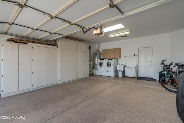 6061 N Tocito Pl, Tucson, AZ 85718 - garage with separate washer and dryer, a garage door opener, and gas water heater