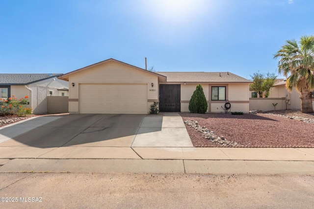 5831 N Moonbrook Rd, Tucson, AZ 85741 - ranch-style house with an attached garage and driveway