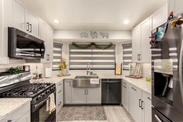 5831 N Moonbrook Rd, Tucson, AZ 85741 - kitchen featuring stainless steel appliances, a sink, tasteful backsplash, light stone counters, and recessed lighting