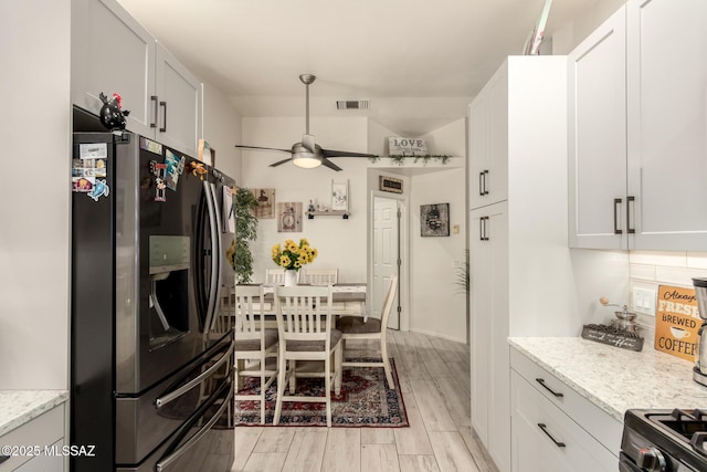 5831 N Moonbrook Rd, Tucson, AZ 85741 - kitchen featuring stainless steel appliances, ceiling fan, light wood-style flooring, light stone countertops, and white cabinetry