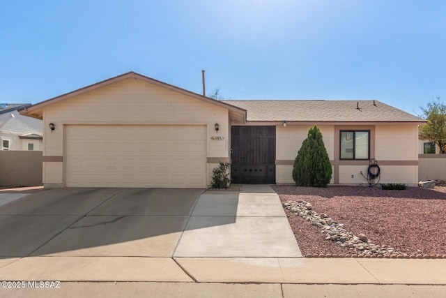 5831 N Moonbrook Rd, Tucson, AZ 85741 - ranch-style home with concrete driveway, a garage, and a shingled roof