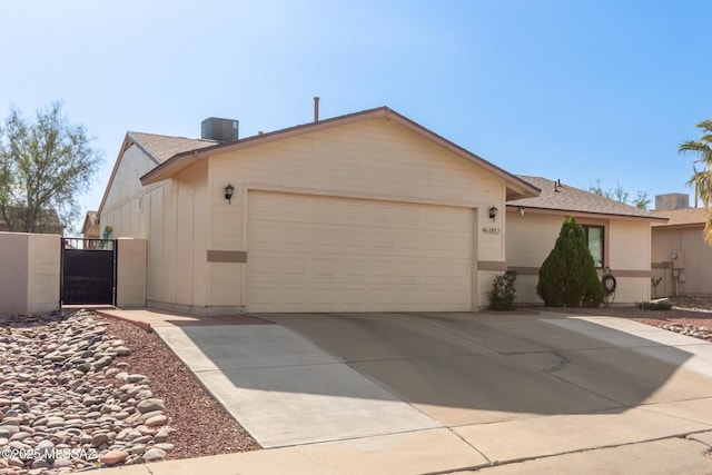 5831 N Moonbrook Rd, Tucson, AZ 85741 - view of front of property featuring a garage, central AC unit, concrete driveway, and a chimney