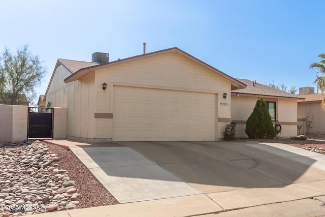 5831 N Moonbrook Rd, Tucson, AZ 85741 - ranch-style house featuring a garage, driveway, roof with shingles, a chimney, and central air condition unit