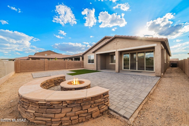 11324 Granite Gulch Way, Tucson, AZ 85747 - back of property featuring an outdoor fire pit, stucco siding, a patio area, a fenced backyard, and central AC unit