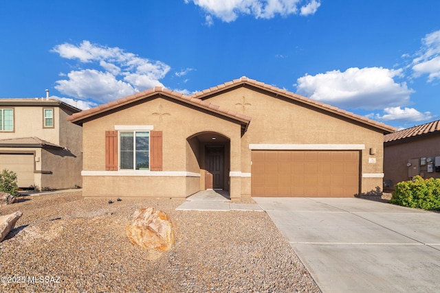 11324 Granite Gulch Way, Tucson, AZ 85747 - mediterranean / spanish house featuring an attached garage, driveway, stucco siding, and a tiled roof