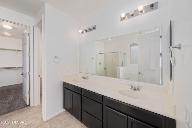 11324 Granite Gulch Way, Tucson, AZ 85747 - full bath with a stall shower, double vanity, a walk in closet, and tile patterned flooring