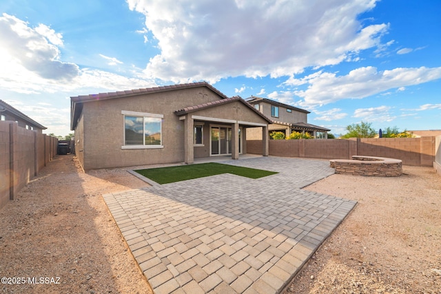 11324 Granite Gulch Way, Tucson, AZ 85747 - rear view of house with a fire pit, a fenced backyard, a patio area, and stucco siding