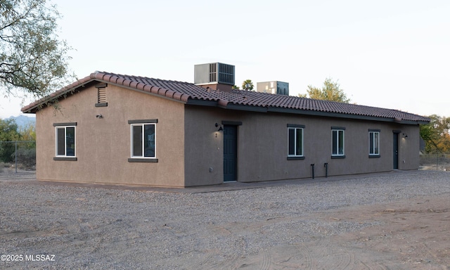 5968 S Stewart Blvd, Tucson, AZ 85706 - back of house featuring a tile roof, central AC, and stucco siding