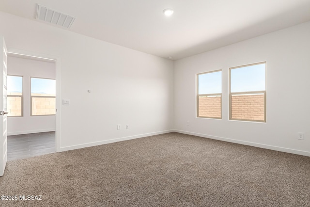 9810 E Gray Hawk Dr, Tucson, AZ 85730 - empty room featuring healthy amount of natural light, carpet flooring, and baseboards