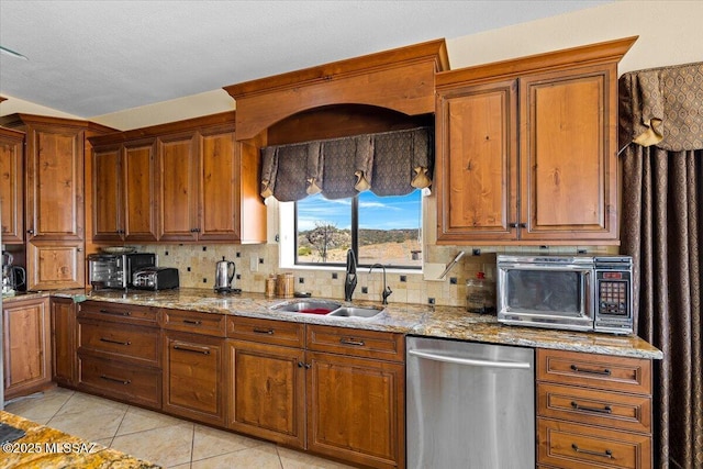 1969 W Three Oclock Hill Rd, Oracle, AZ 85623 - kitchen featuring appliances with stainless steel finishes, tasteful backsplash, light tile patterned floors, and brown cabinetry