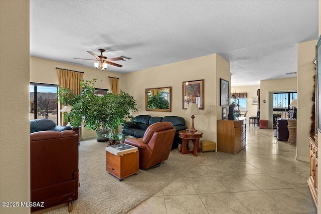 1969 W Three Oclock Hill Rd, Oracle, AZ 85623 - living area featuring a ceiling fan, a textured ceiling, plenty of natural light, and light tile patterned floors