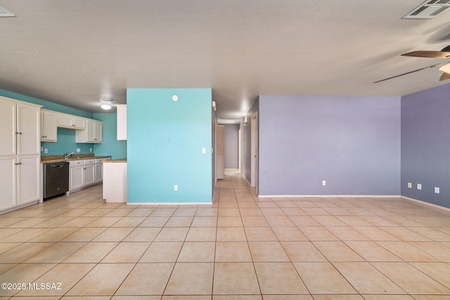 1448 N Calle Futura, Oracle, AZ 85623 - kitchen with black dishwasher, ceiling fan, white cabinets, light tile patterned floors, and baseboards