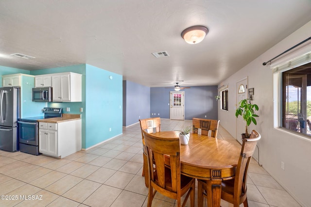 1448 N Calle Futura, Oracle, AZ 85623 - dining area featuring light tile patterned floors, a ceiling fan, and baseboards