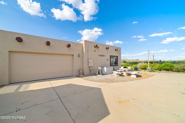 1448 N Calle Futura, Oracle, AZ 85623 - back of property featuring concrete driveway, stucco siding, and a garage