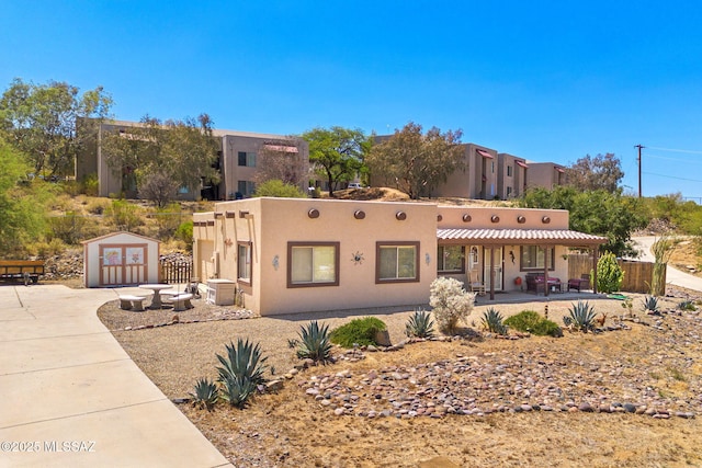 1448 N Calle Futura, Oracle, AZ 85623 - pueblo-style house with stucco siding and a porch