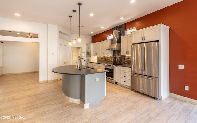 13570 N Nightstar Ct, Marana, AZ 85658 - kitchen featuring appliances with stainless steel finishes, a sink, dark countertops, wall chimney range hood, and a center island with sink