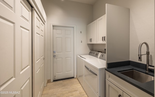 13570 N Nightstar Ct, Marana, AZ 85658 - laundry room with cabinet space, washing machine and dryer, and light wood finished floors