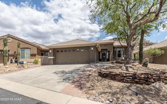 13570 N Nightstar Ct, Marana, AZ 85658 - view of front of home with a garage, concrete driveway, a tiled roof, and stucco siding