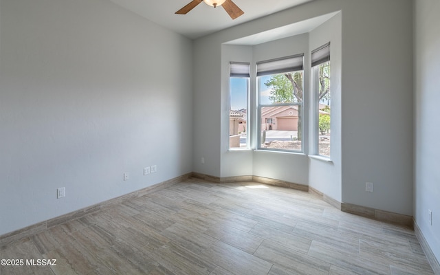 13570 N Nightstar Ct, Marana, AZ 85658 - empty room featuring a ceiling fan and baseboards