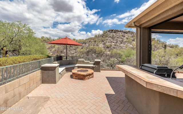 13570 N Nightstar Ct, Marana, AZ 85658 - view of patio / terrace featuring a fire pit and exterior kitchen