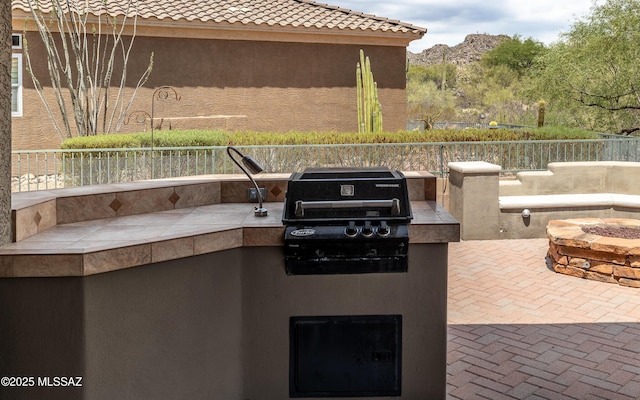 13570 N Nightstar Ct, Marana, AZ 85658 - view of patio / terrace with an outdoor fire pit and a mountain view