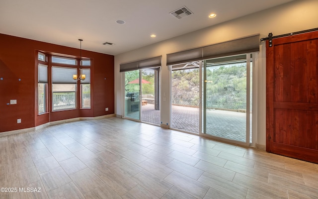 13570 N Nightstar Ct, Marana, AZ 85658 - empty room featuring baseboards, a chandelier, recessed lighting, and a barn door